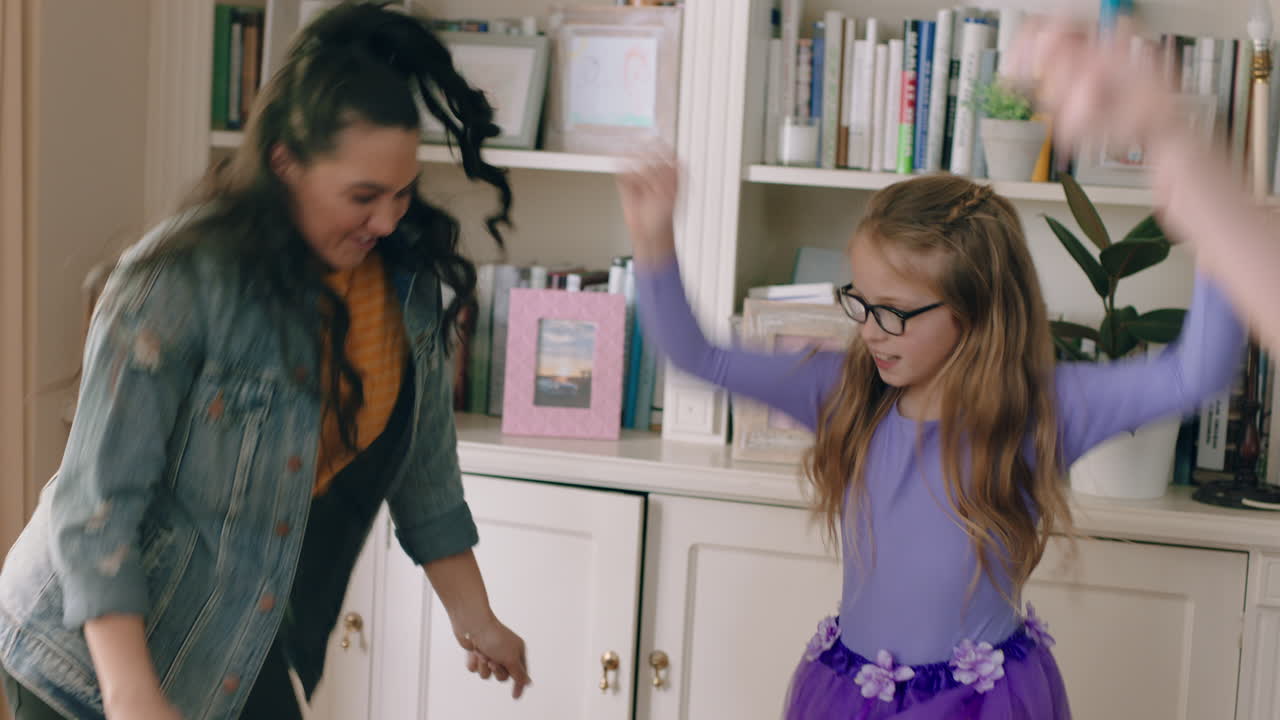 happy multiracial family dancing at home having fun enjoying dance celebrating exciting weekend together