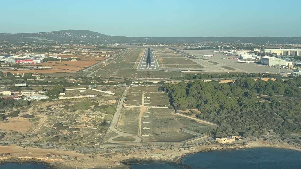 aproximación en tiempo real a la tierra vista por los pilotos en un aeropuerto costero , con la vista de la silueta del avión por delante sobre el suelo