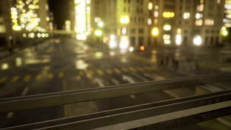 city street at night with illuminated buildings and wet pavement