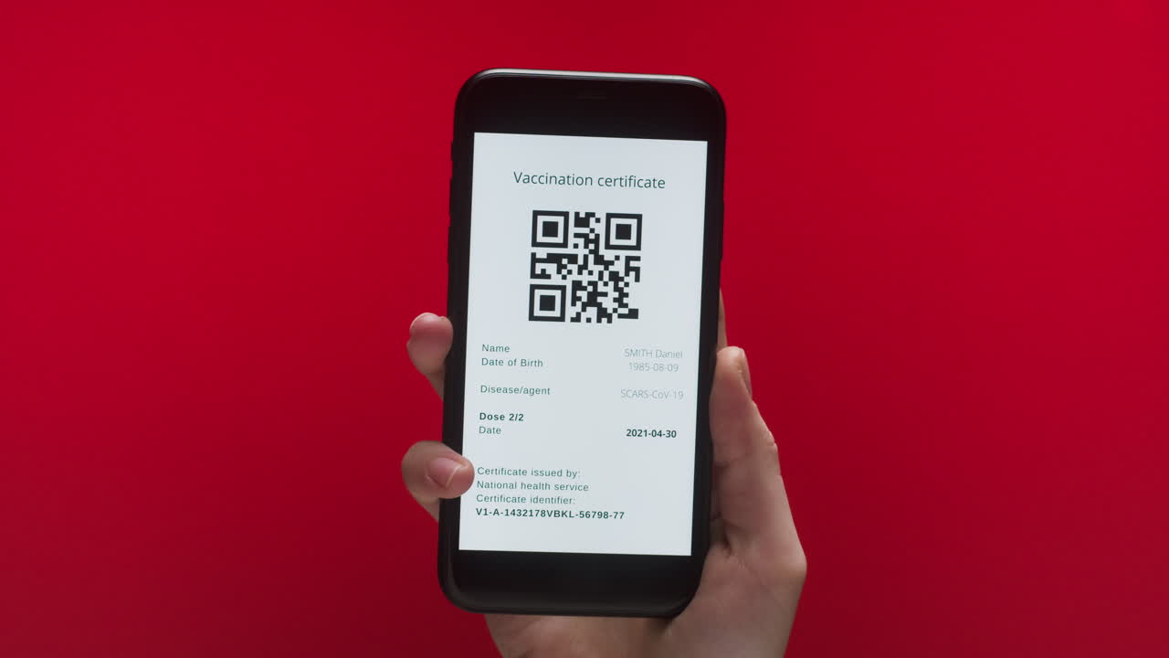 Hand Holding Smartphone Displaying Digital Vaccination Certificate with QR Code