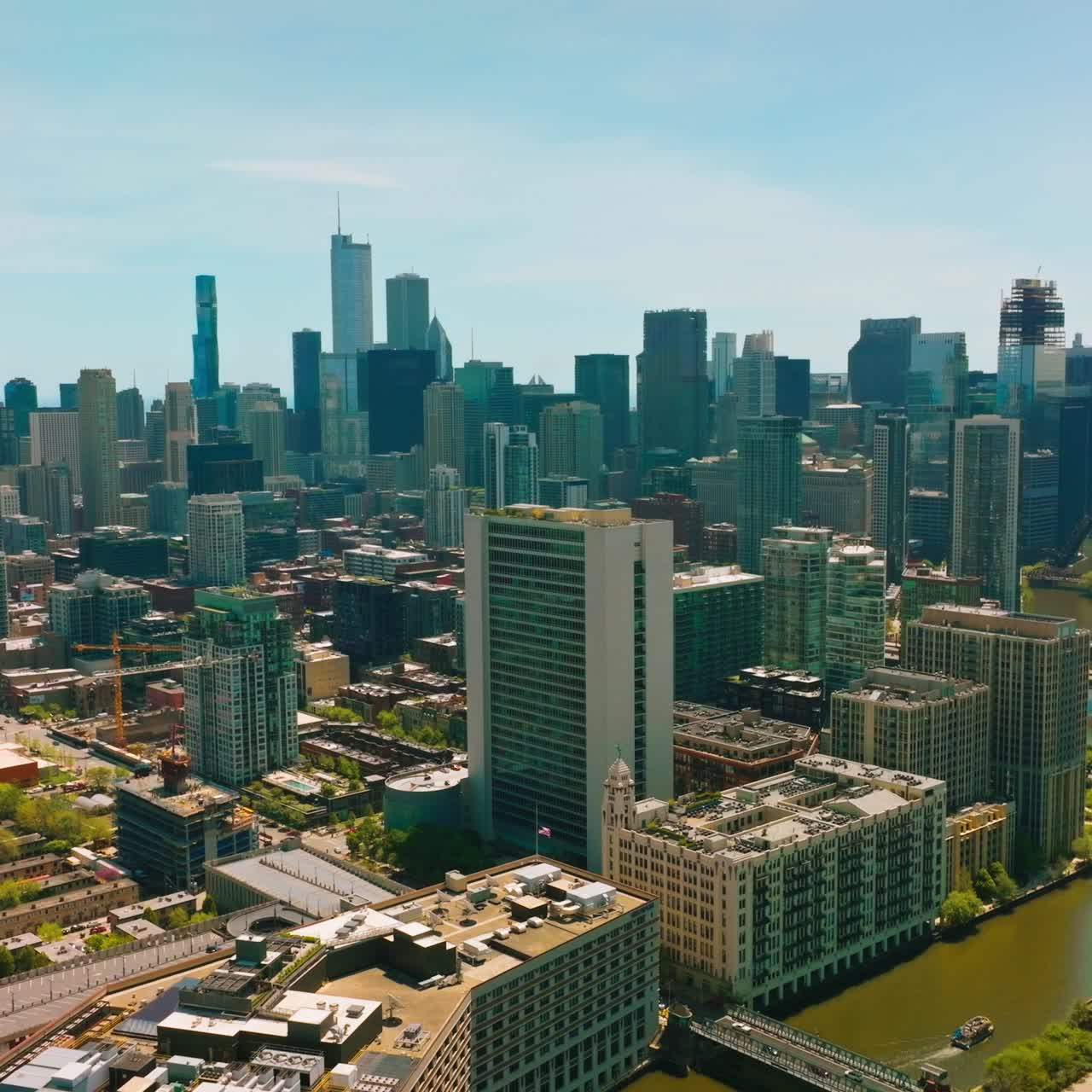 Rio correndo entre os edifícios de Chicago. Drone sobrevoando a bela arquitetura da metrópole. Arranha-céus ao fundo