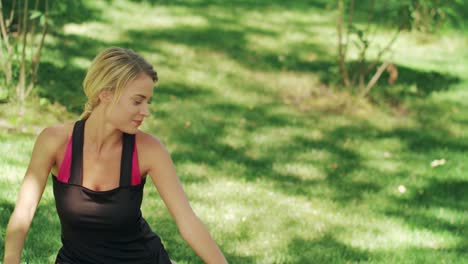 smiling woman stretching legs before fitness gym in park. fitness woman