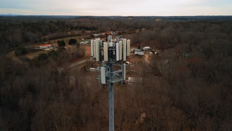 aerial shot revealing cell phone tower in forest. 4k drone