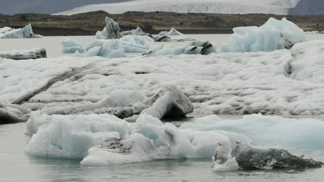 icebergs floating across the jokulsarlon lagoon in iceland - a stark reminder of global warming and climate change issues