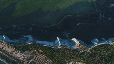 aerial view of a scenic landscape with cliffs and fields