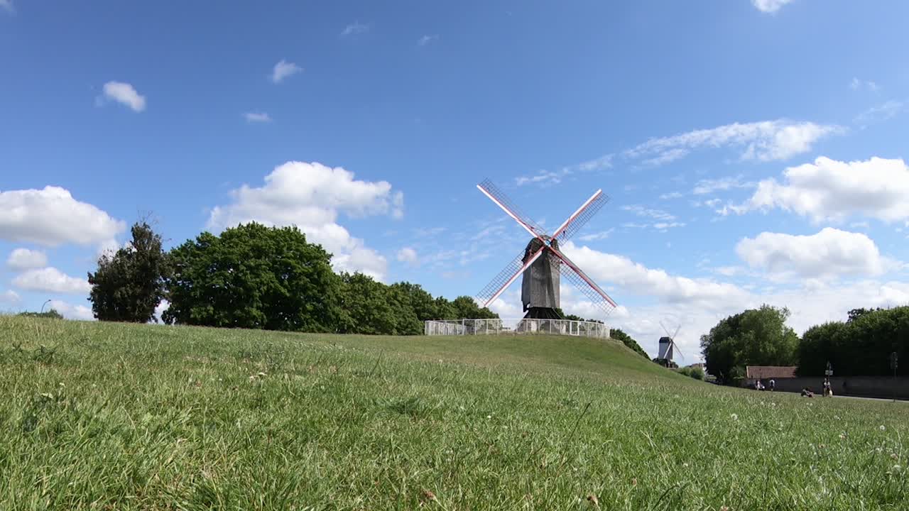 Sint-Janshuismill Windmill at a Park in the City of Bruges on a Beautiful Summer Day