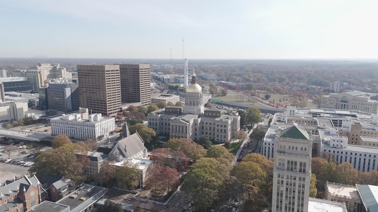 Aerial view of downtown Atlanta, Georgia, showcasing the Georgia State Capitol with its golden dome and surrounding urban landscape.