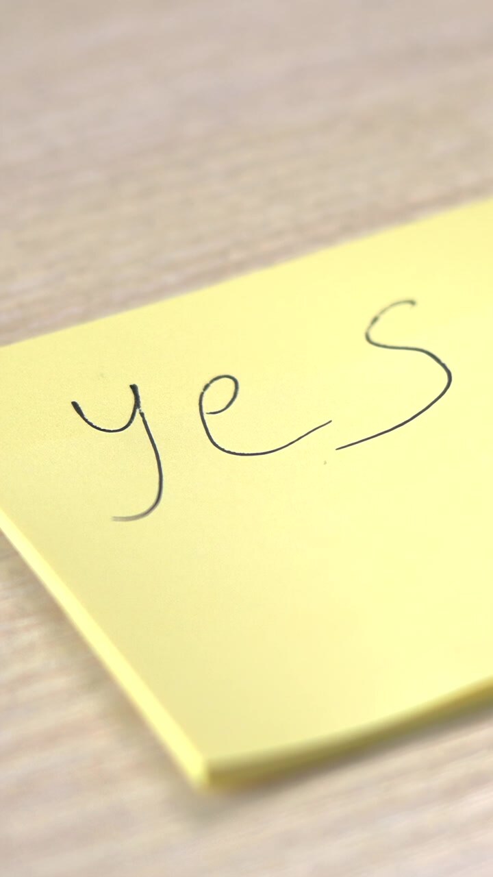 Yellow Sticky Note With Yes Written On Wood Desk Beside Black Pen, Shallow Depth Of Field And Soft Natural. Media