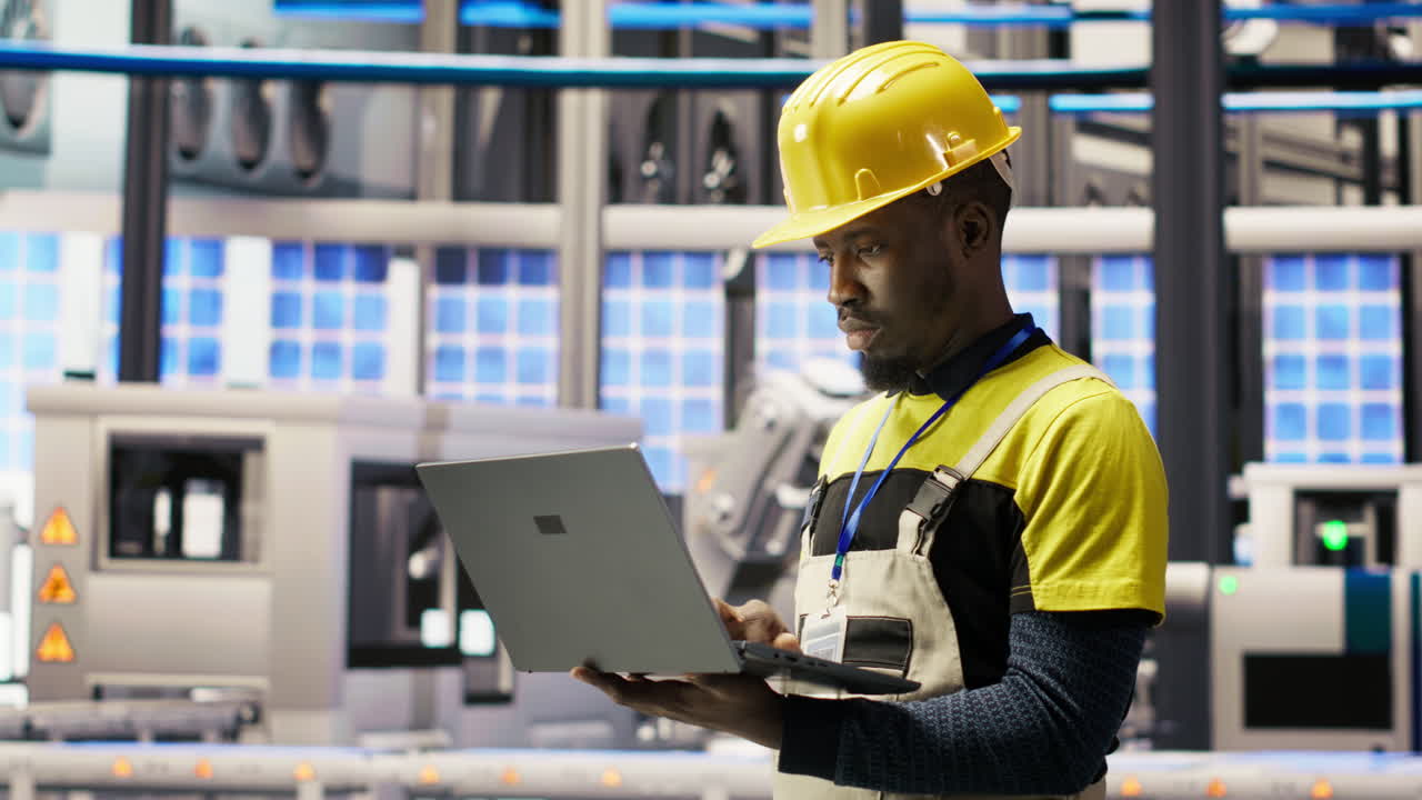 Vertical video Technician in smart factory using notebook to look at system performance metrics