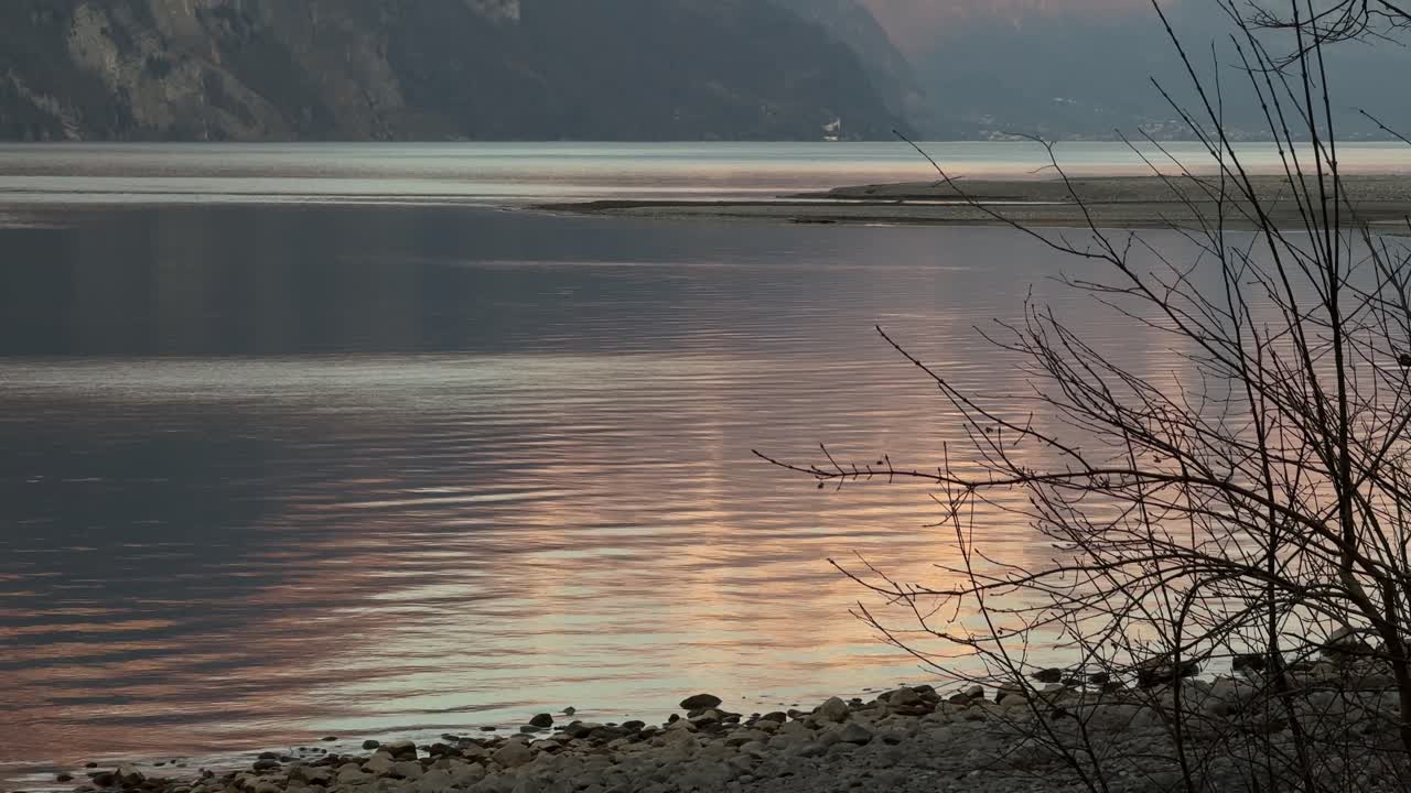 Calm lake water ripples reflection sun Walensee Walen Switzerland relaxing serene