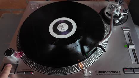 pov shot of a person starting a turntable player