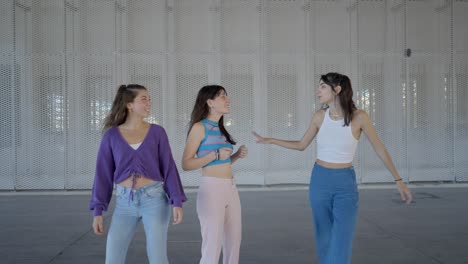 three young women having a conversation outdoors