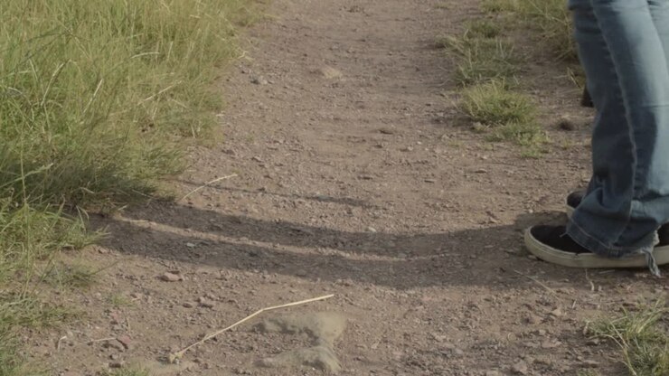 Hiker sets off on with backpack and walking stick