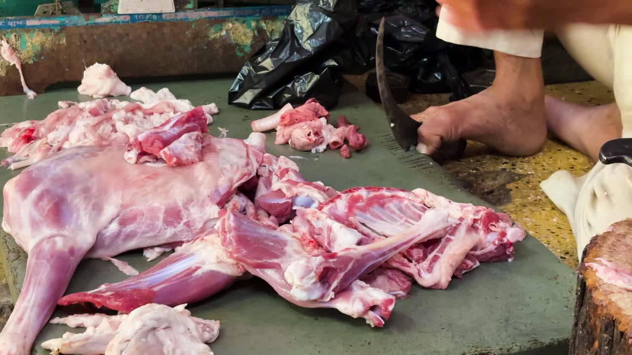 close up of butcher hands cutting fresh meat portions for sale at market