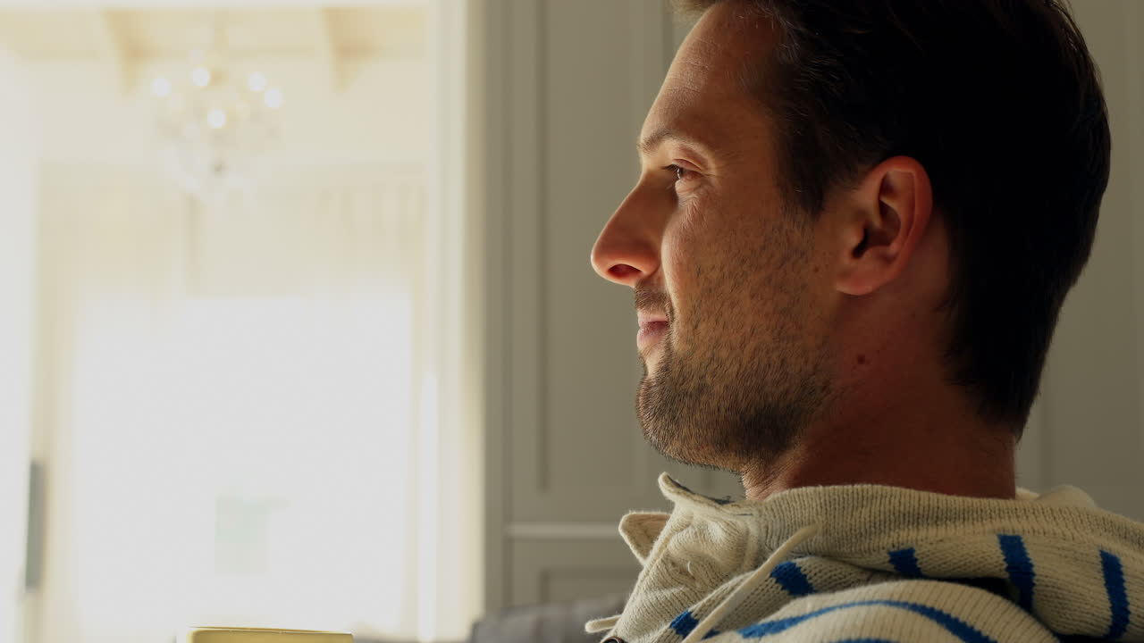 Man having cup of coffee at home 4k