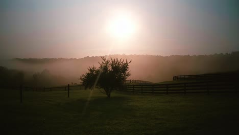 sunrise over the misty farm fields