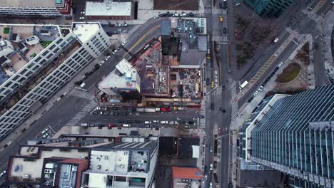 aerial view above a urban construction site in middle of high-rise in queens, ny - overhead, drone shot