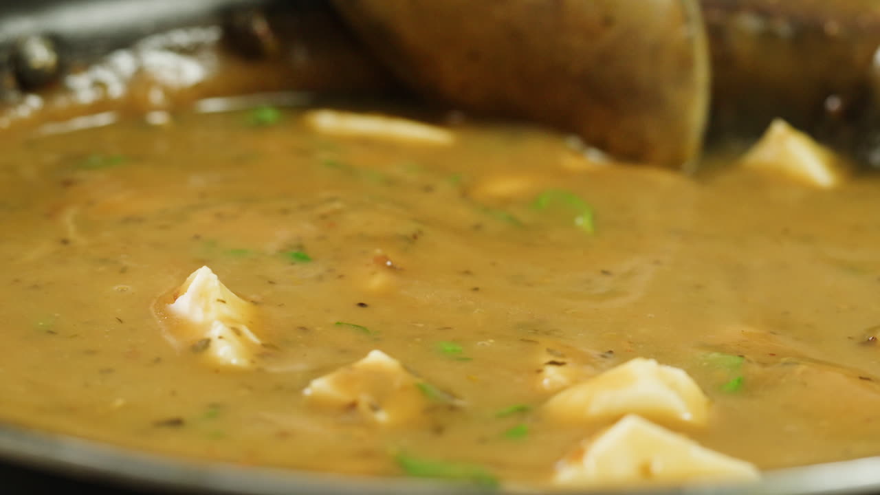 Cooking traditional Indian meal Palak Panir with spinach and cheese close up. Palak paneer is an Indian dish, consisting of paneer in a thick paste made from pureed spinach, Palak paneer is prepared by first boiling and pureeing spinach.