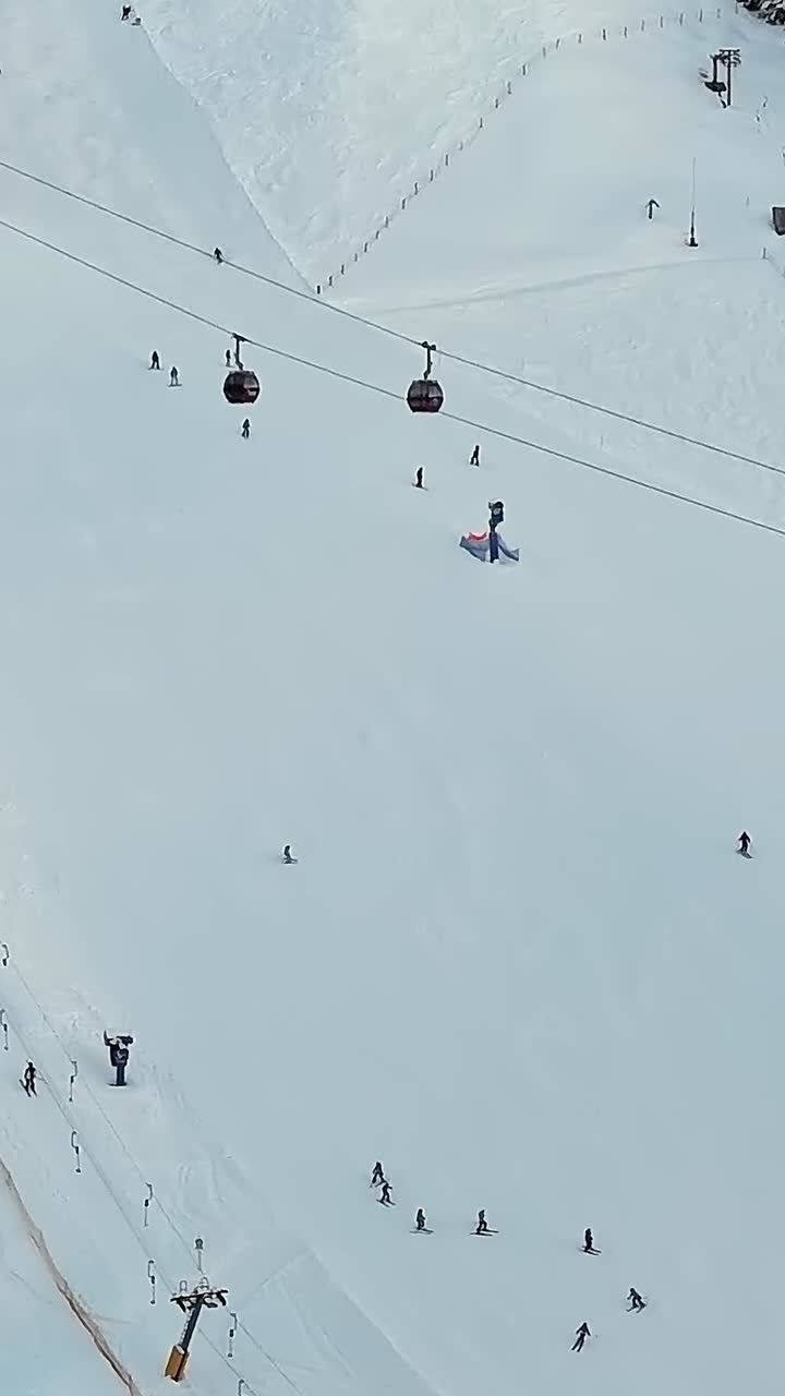 Skiers and snowboarders enjoy winter on the slopes in the Alps, Italy