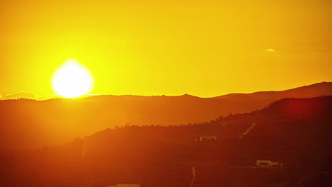 a time lapse shot of smooth sunset scene in the mountains at the golden hour