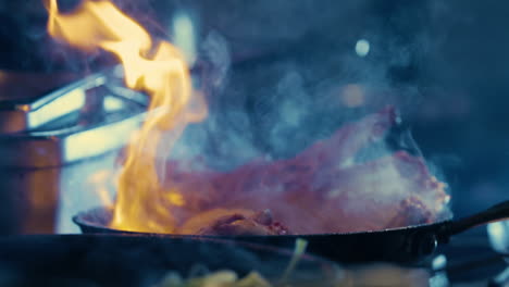 delicious lamb chops are cooked in a flaming frying pan