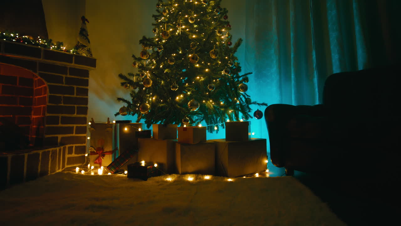 Room decorated with a Christmas tree and gift packages at night