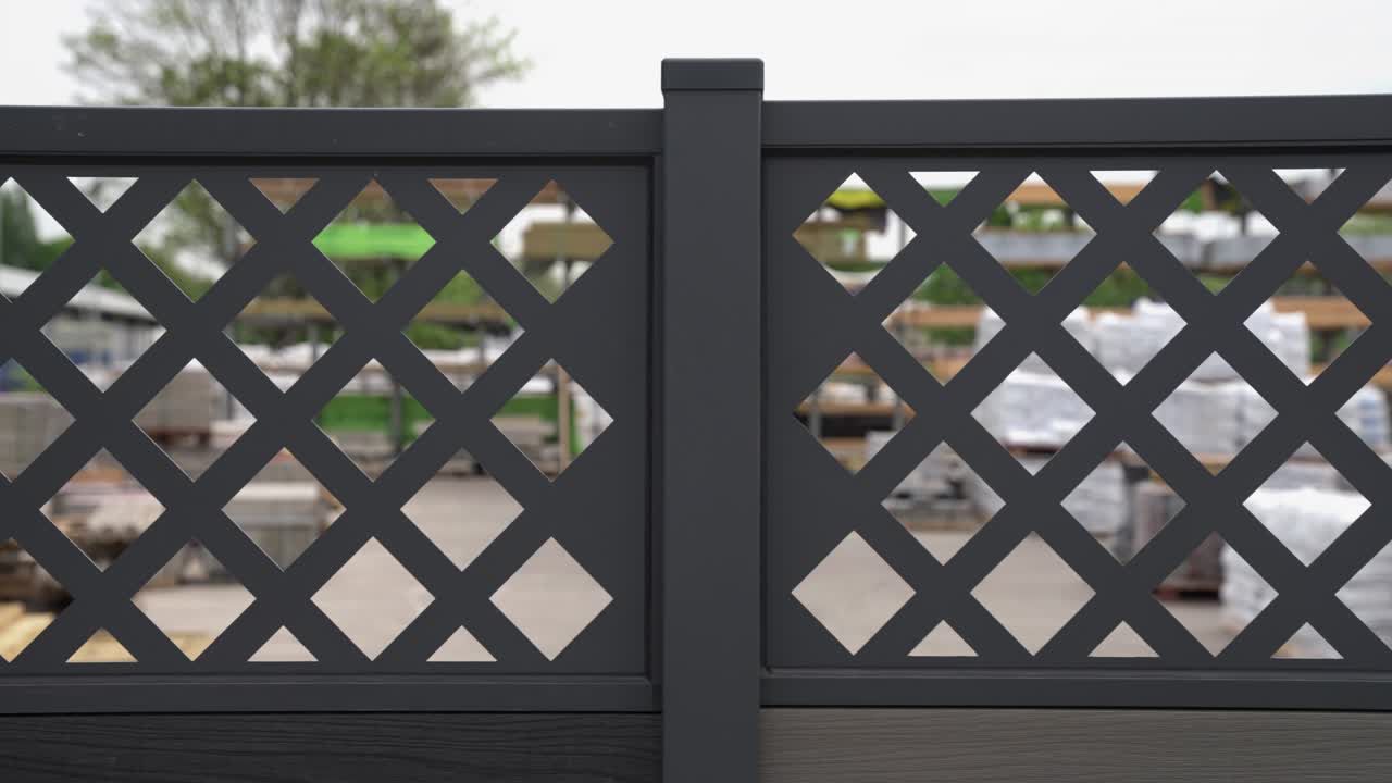 Close up of fence panel design with square diamond cut outs creating a luxury look on dark grey plastic for modern look