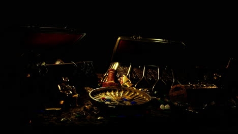 handful of gold jewelry on a dark background