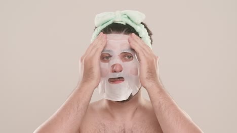 man wearing a facial sheet mask