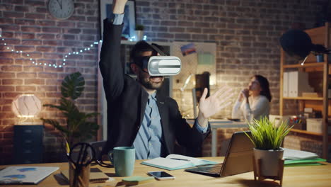 businessman experiencing virtual reality in the office at night