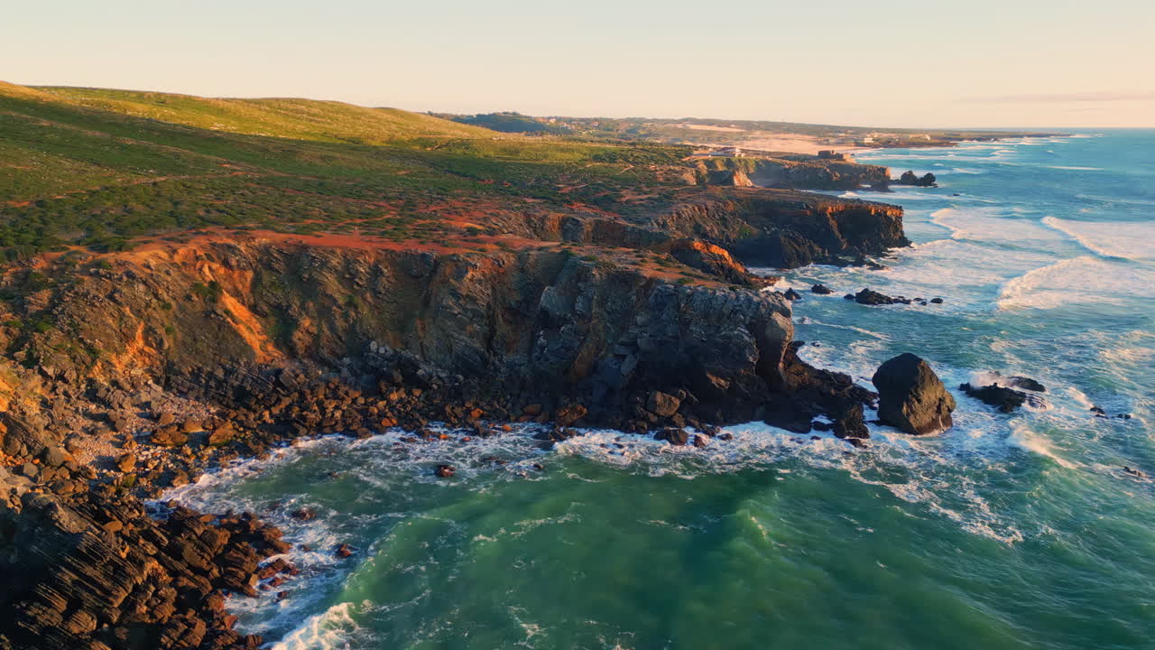 Ocean swell grassy cliffs landscape aerial view. Foaming waves rolling coastline