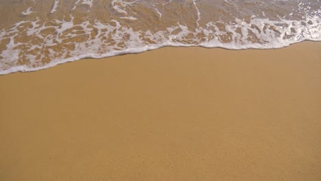 ocean waves rolling into a sandy beach in slow motion 180fps