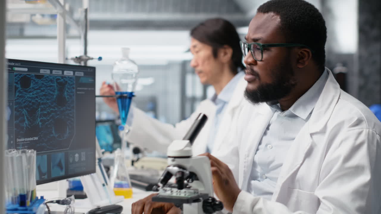 Vertical video Clinical microbiologist uses microscope for sample observation using PC software