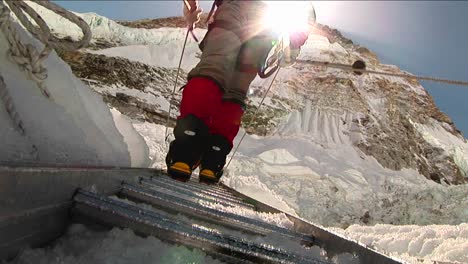 closeup of crampons on ladder rungs