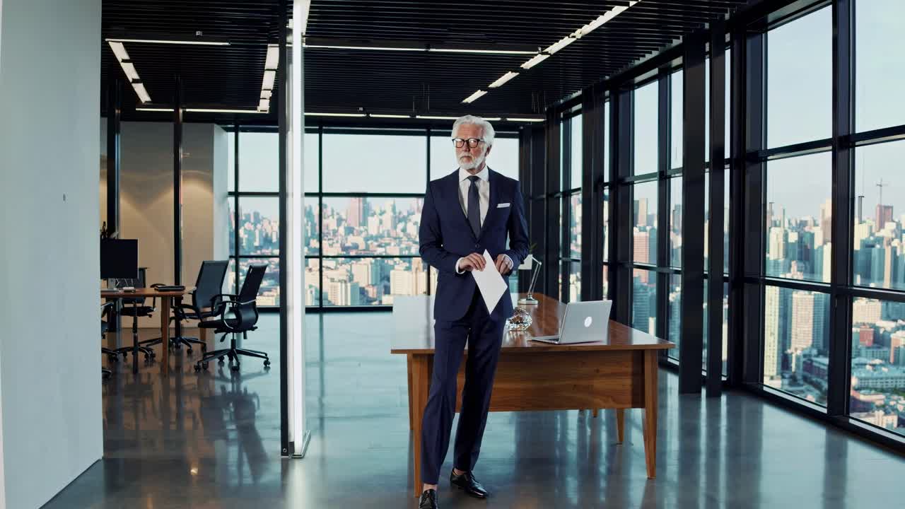 A high-angle video shot of a sophisticated office with a man in a suit, large windows, and cityscape