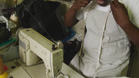 african man preparing the thread for sewing