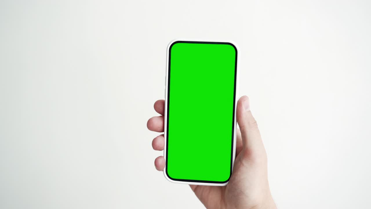 Young Person Use Smartphone with Green Screen Chroma Key Close-up. Guy Hold in Hand Cell Phone Mock-up POV. Concept Watch and Show Internet Social Media, Video Calls, Read News, App, iot, e-Shopping