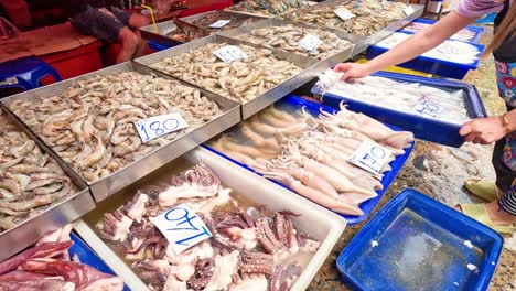 customer and vendor interacting at seafood stall