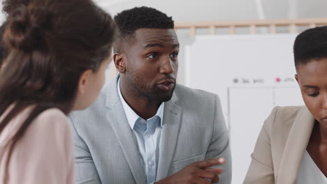 corporate-business-team-meeting-african-american-businessman-brainstorming-with-colleagues-discussing-project-strategy-sharing-ideas-in-office