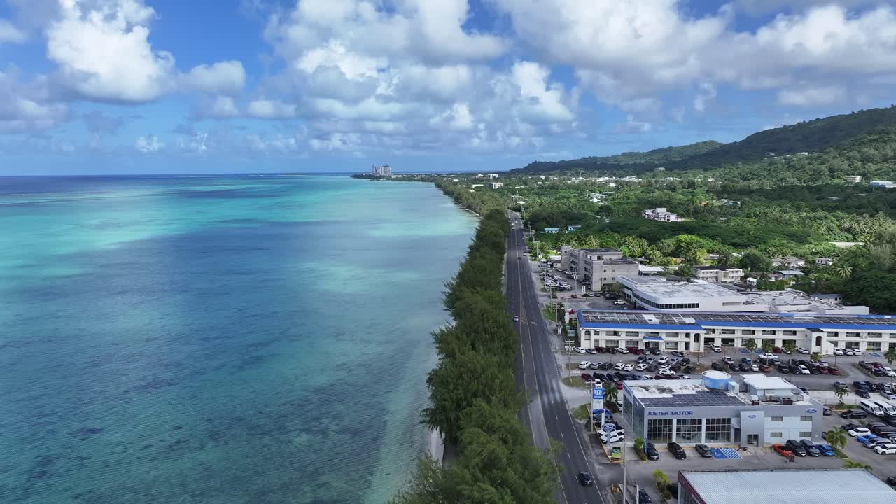 Trace the path of endurance in paradise. This sweeping aerial footage captures the renowned coastal running course along Saipan's west coast, famous for hosting international marathons. Stretching fro