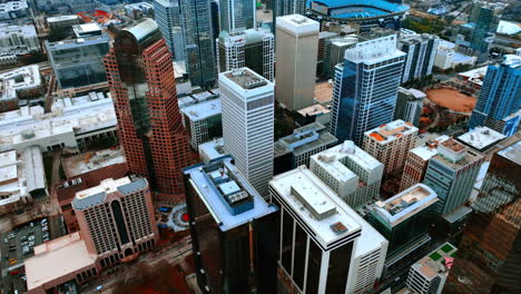 distancing from variety of high-rise buildings in boston downtown. setting sun lighting the panorama of massachusetts capital. aerial view. vertical video