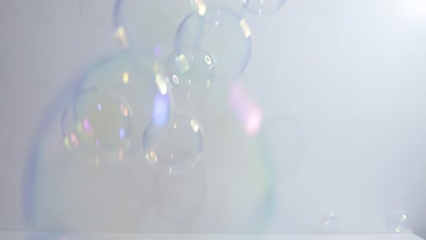 clear bubbles falling in front of white background