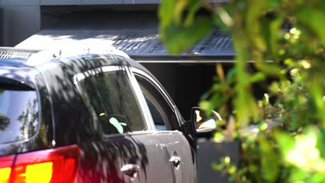 Shot-of-smart-house-garage-door-opening-as-car-drives-in