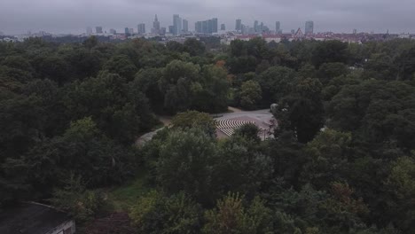 Short-drone-video-of-warsaw-city-skyline-above-a-forest-from-a-distance