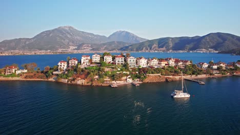 Low-Panorama-Landscape-of-Knight-Island,-with-Turkish-Mountains-in-the-Background