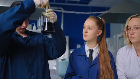 students performing a chemistry experiment in a lab