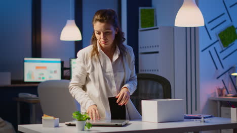 Upset-dismissed-woman-employee-putting-her-stuff-in-box