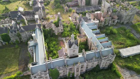 haunted denbigh lunatic asylum, north wales, aerial clockwise fast rotate and pull back, sunny afternoon