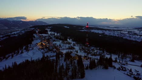 snowy zakopane town in the evening in poland - aerial drone shot