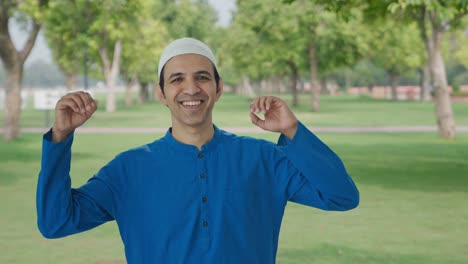 happy muslim man dancing and enjoying in park
